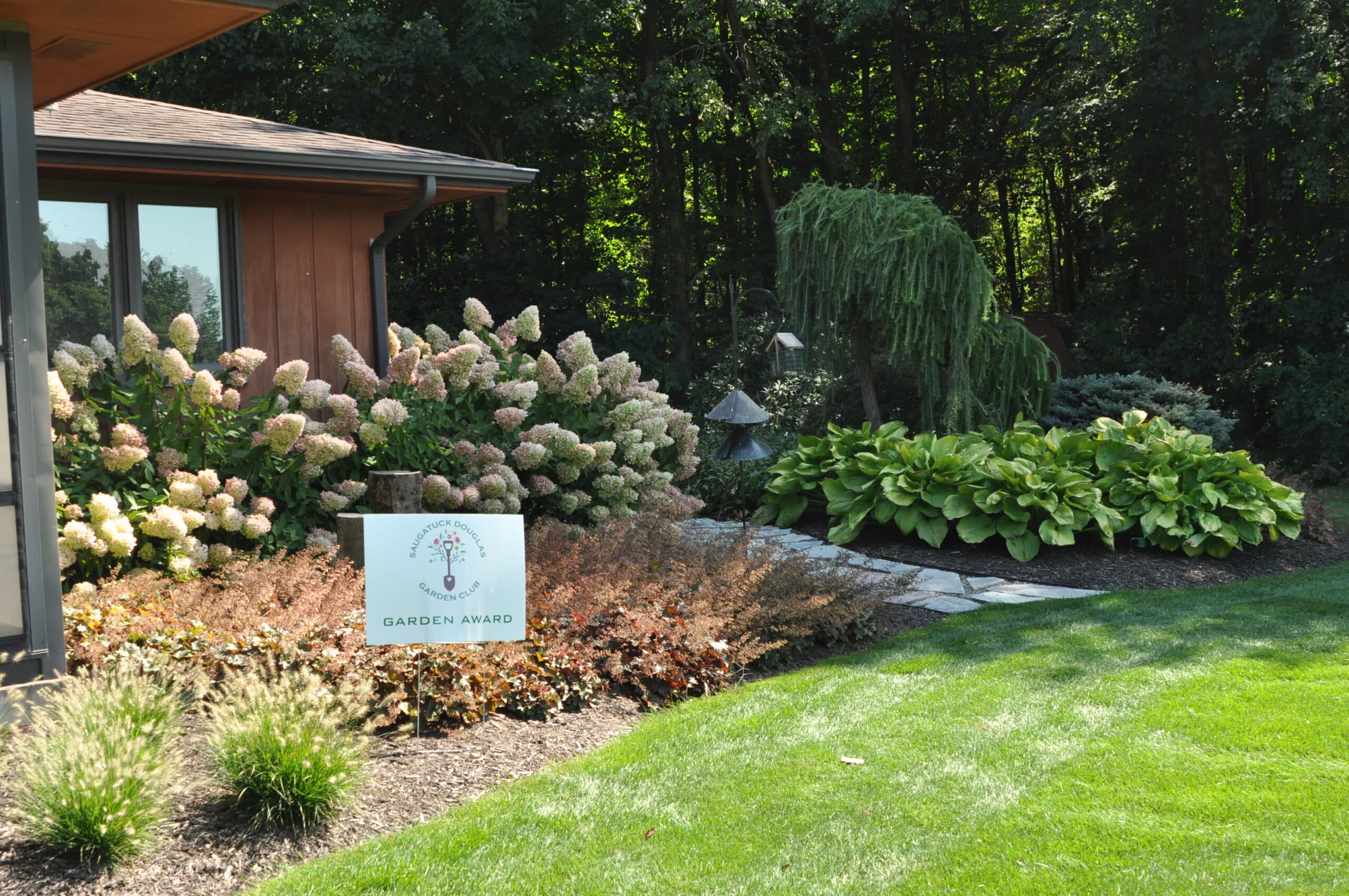 Tourists exploring private shade garden on Garden Walk