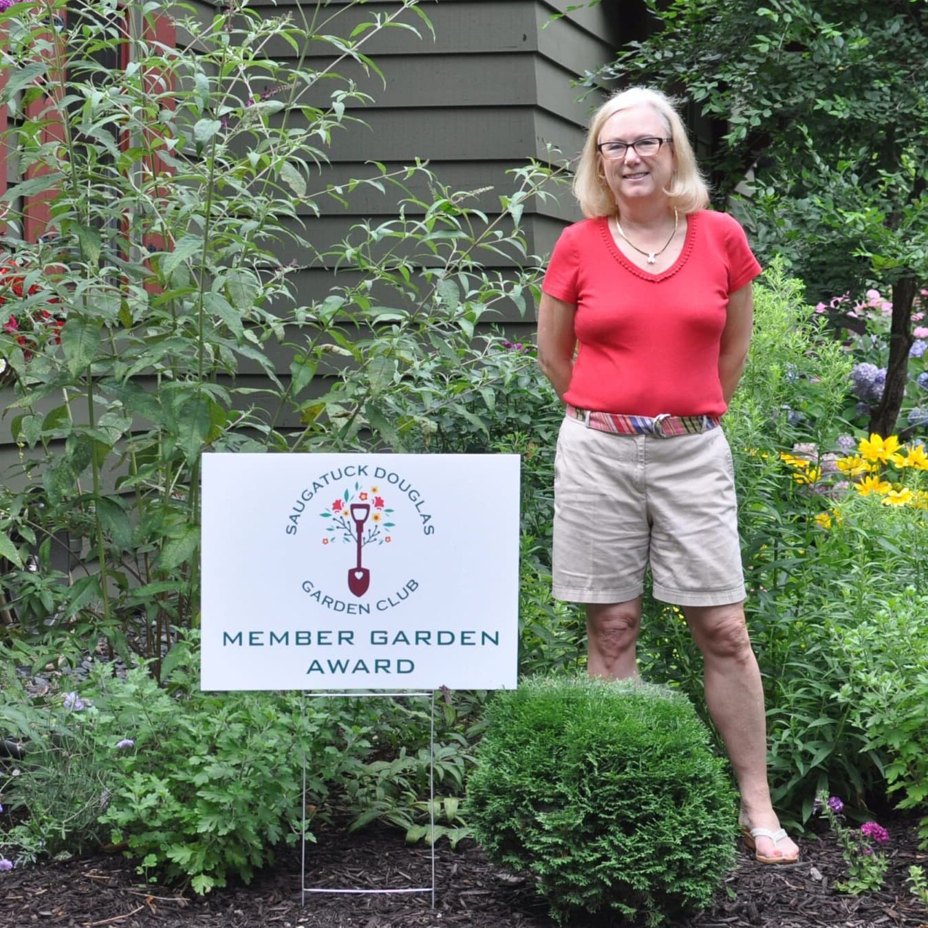 Flower Power garden award lawn sign in a blooming residential garden